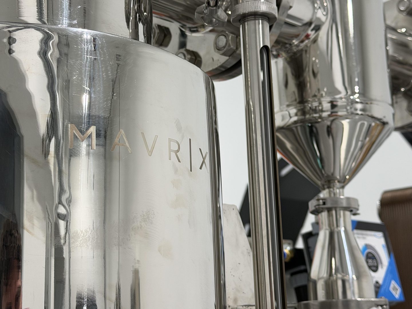 Close-up of polished stainless-steel Hydron equipment with the Mavrix name etched into the vessel.