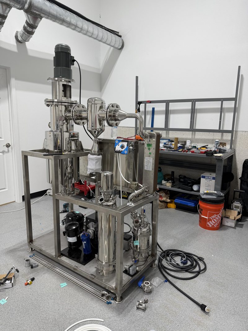 The Hydron prototype: a stainless-steel purification rig on a two-level frame, photographed in the workshop.